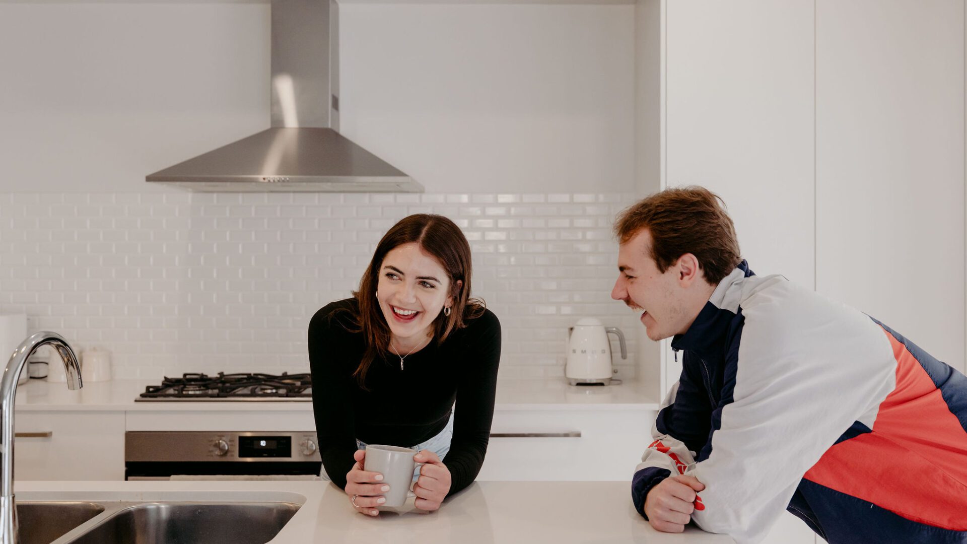 Dalyellup client home lifestyle photoshoot with Skylar and Dylan leaning on kitchen island benchtop