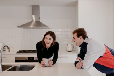 Dalyellup client home lifestyle photoshoot with Skylar and Dylan leaning on kitchen island benchtop