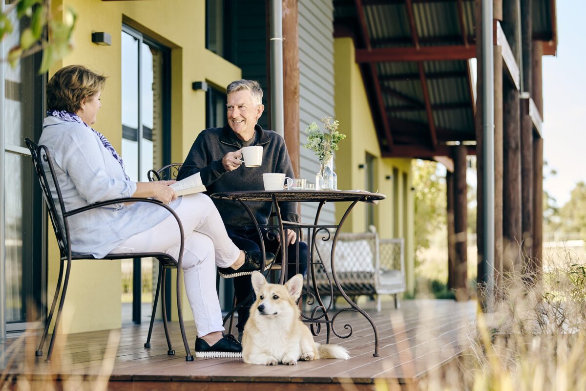 The Hinterland lifestyle shoot with a retired couple and their corgi, having tea on their porch